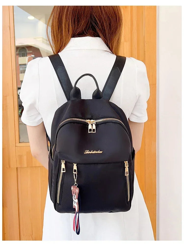 2024 Women's New Solid Color Zipper Waterproof Nylon Fashion Backpack Large Capacity Casual and Versatile Commuting Backpack