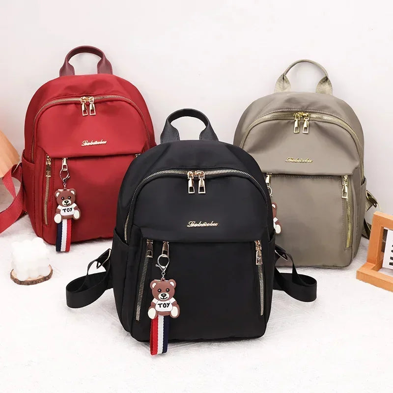 2024 Women's New Solid Color Zipper Waterproof Nylon Fashion Backpack Large Capacity Casual and Versatile Commuting Backpack