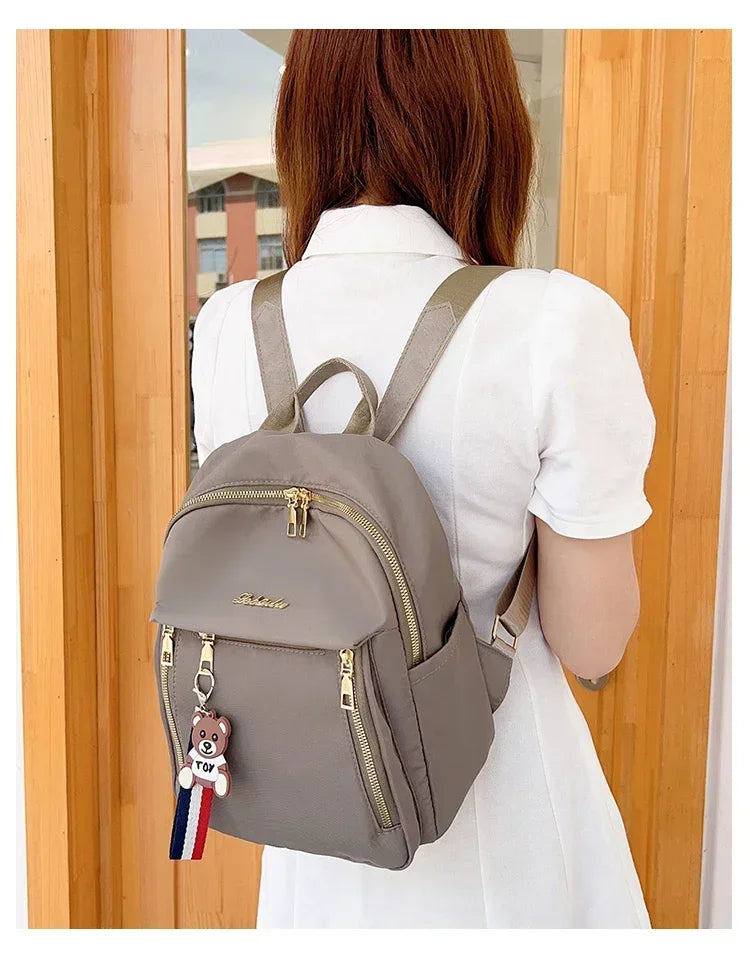 2024 Women's New Solid Color Zipper Waterproof Nylon Fashion Backpack Large Capacity Casual and Versatile Commuting Backpack