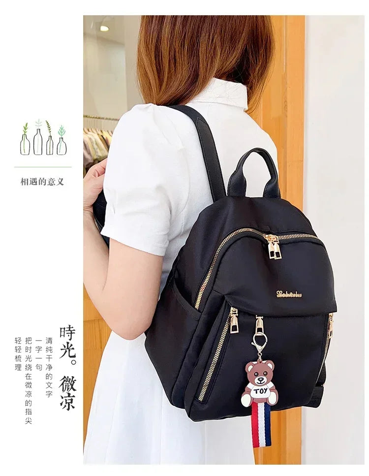 2024 Women's New Solid Color Zipper Waterproof Nylon Fashion Backpack Large Capacity Casual and Versatile Commuting Backpack