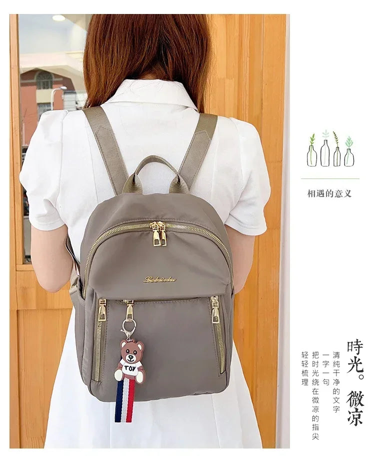 2024 Women's New Solid Color Zipper Waterproof Nylon Fashion Backpack Large Capacity Casual and Versatile Commuting Backpack