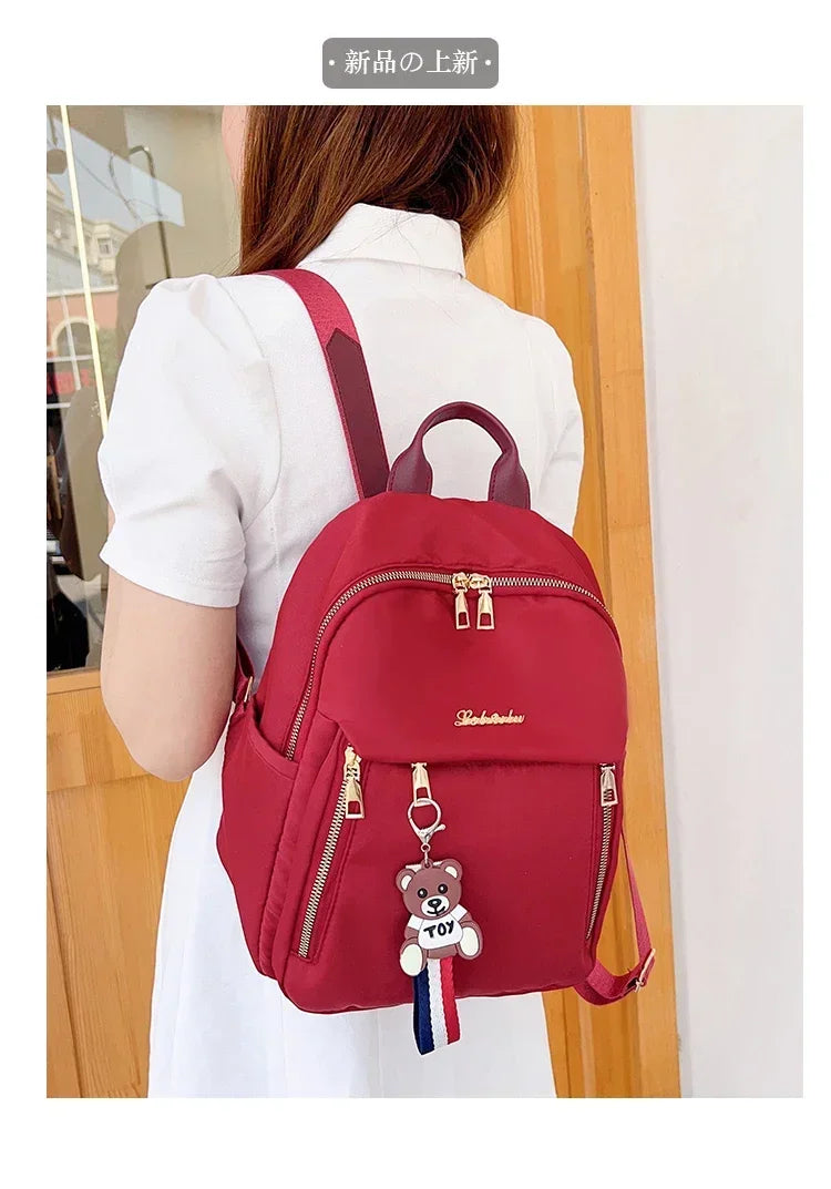 2024 Women's New Solid Color Zipper Waterproof Nylon Fashion Backpack Large Capacity Casual and Versatile Commuting Backpack